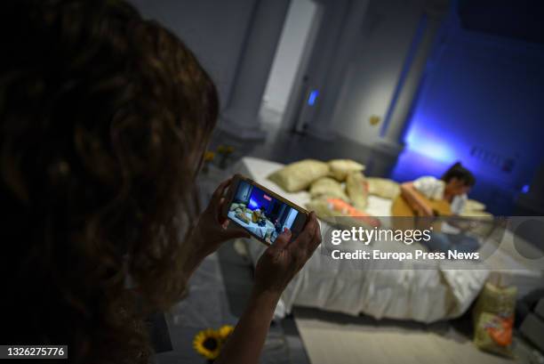 Person photographs the singer Dani while she performs a song during the presentation of the project 'El Dormitorio. Centennial Bedroom Art', on June...