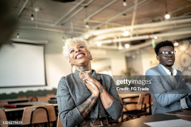 businesswoman applauding at business meeting - hipster office stock pictures, royalty-free photos & images