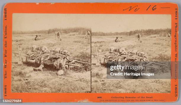 This photographic print stereograph shows a stretcher or litter in the foreground with several skeletal human remains piled on it. Clothing remains...