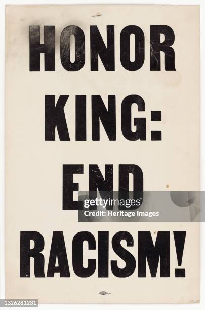 Placard comprised of black ink on white card stock. Text reads [HONOR/ KING: / END/ RACISM!]. There is a small hole at the top where the placard...