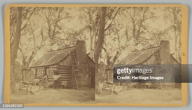 Stereograph titled 'Plantation Scene; Folks All Home' printed by J. N. Wilson of Savannah, Georgia. The albumen prints depicts six unidentified...