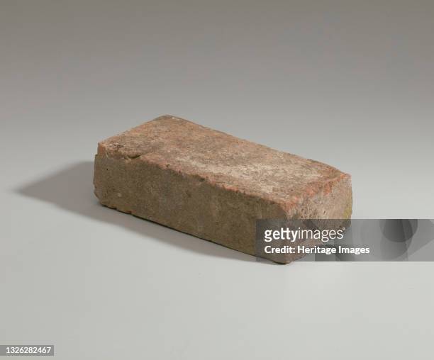 Solid clay brick, a medium beige in color, with uneven edges and surfaces, taken from the brick house built built and kept by Nelson Davis and...