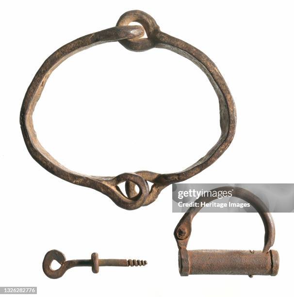 Wrought iron collar with a three inch locking device and a three inch key. The collar is made up of two pieces of iron attached with a hinged, chain...