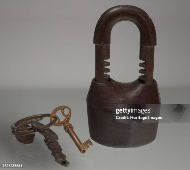 Two piece iron padlock with a set of two different keys and a tag. The lock consists of two separate cast iron pieces, the body and the shackle ....