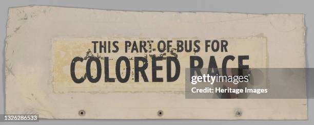 Metal bus sign with a stenciled black paint in black that reads: [THIS PART OF BUS FOR / COLORED RACE]. In 1960, students planned, coordinated and...