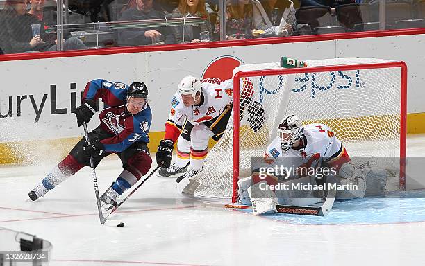 Ryan O'Byrne of the Colorado Avalanche skates around the goal against Jay Bouwmeester of the Calgary Flames at the Pepsi Center on November 12, 2011...