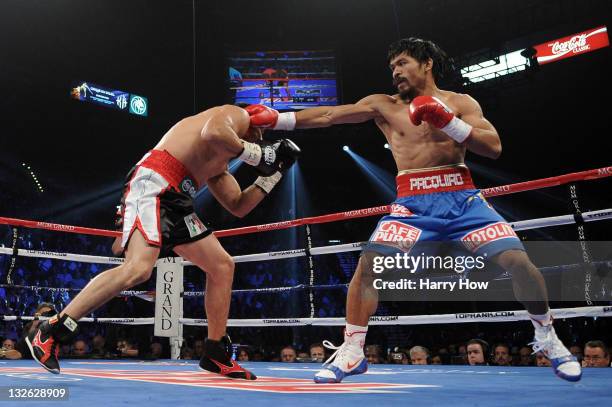 Manny Pacquiao throws a right to the body of Juan Manuel Marquez during the WBO world welterweight title fight at the MGM Grand Garden Arena on...