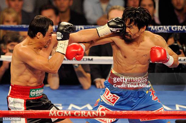 Juan Manuel Marquez connects with a left to the head of Manny Pacquiao during the WBO world welterweight title fight at the MGM Grand Garden Arena on...