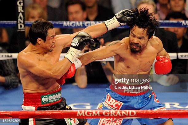 Juan Manuel Marquez and Manny Pacquiao exchange blows during the WBO world welterweight title fight at the MGM Grand Garden Arena on November 12,...