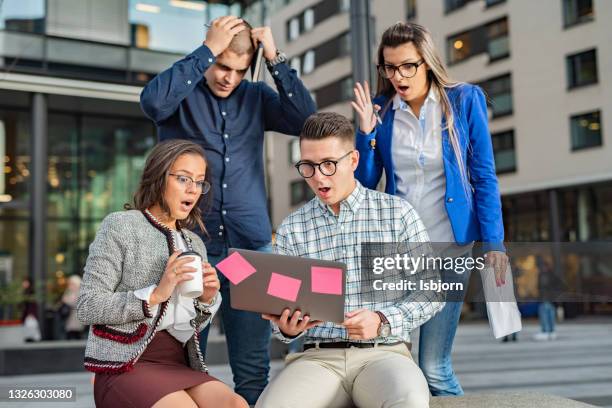 shocked team of entrepreneurs reading an e-mail on laptop - stereotypical stock pictures, royalty-free photos & images