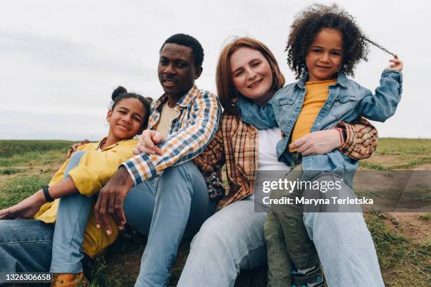 happy international family in nature. - multicultural family stock pictures, royalty-free photos & images