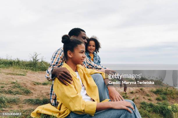 happy international family in nature. - family health club stock pictures, royalty-free photos & images