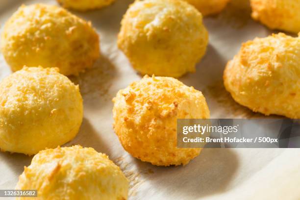 close-up of fried dumplings in tray on table - pão de queijo stock pictures, royalty-free photos & images