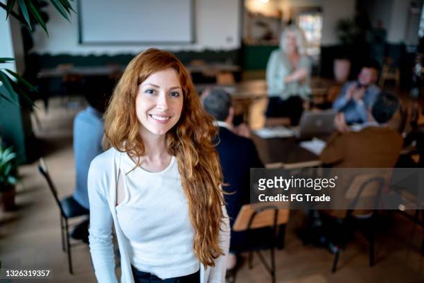 portrait of a young businesswoman with coworkers on the background - founder stock pictures, royalty-free photos & images