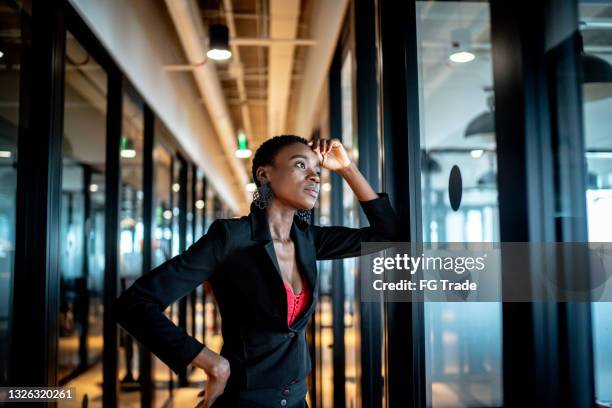 young business woman looking away and contemplation at work - mistaken identity stock pictures, royalty-free photos & images