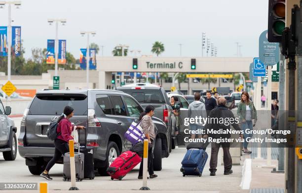 Santa Ana, CA Travelers are dropped off at John Wayne Airport in Santa Ana, CA on Wednesday, June 30, 2021. Free from most of the COVID-19...