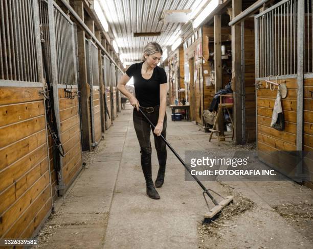 young female trainer doing chores - vegen stockfoto's en -beelden