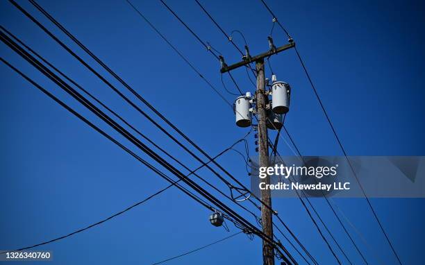 Power lines on utility poles in Smithtown, New York on June 29, 2021.