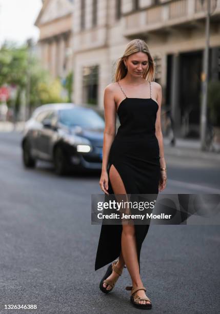 Carolin Niemczyk wearing black The Attico dress and brown prada sandals on June 25, 2021 in Berlin, Germany.
