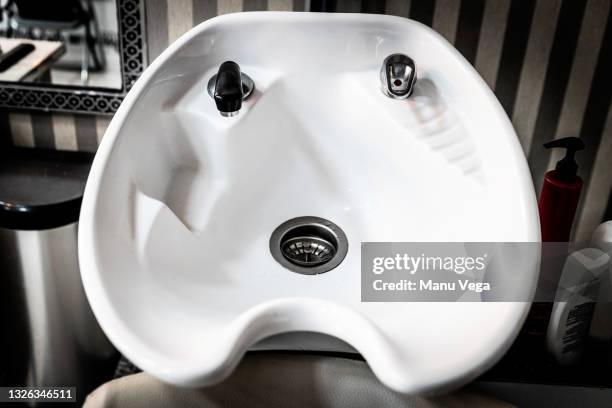 detail view of white sink of hairdresser - hairdresser washing hair stock pictures, royalty-free photos & images