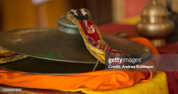 a close up of a traditional tibetan buddhist brass bell cymbals in a tibetan buddhist monastery in pokhara, nepal - tibetan buddhism stock pictures, royalty-free photos & images