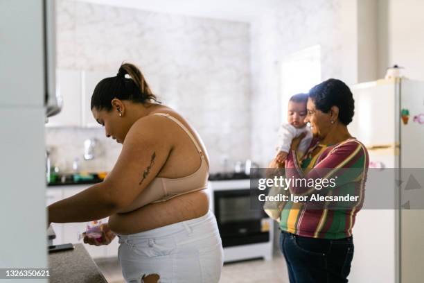 grandmother holding granddaughter - big papa plump stock pictures, royalty-free photos & images