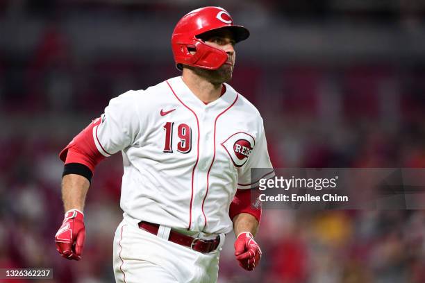 Joey Votto of the Cincinnati Reds runs the bases after hitting a solo home run in the third inning for his 1000th career RBI during their game...