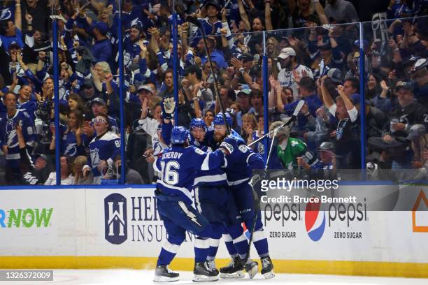Ondrej Palat of the Tampa Bay Lightning is congratulated by his teammates after scoring a goal against the Montreal Canadiens during the third period...