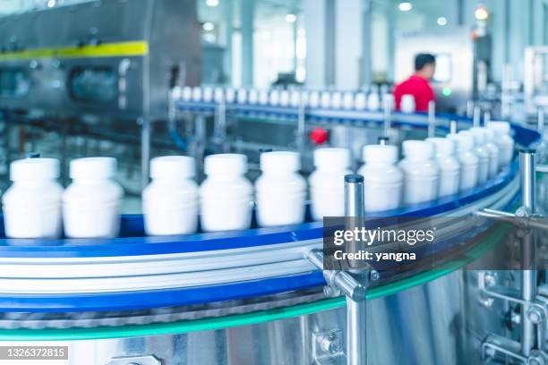 automated factory milk production process - bottling plant stock pictures, royalty-free photos & images