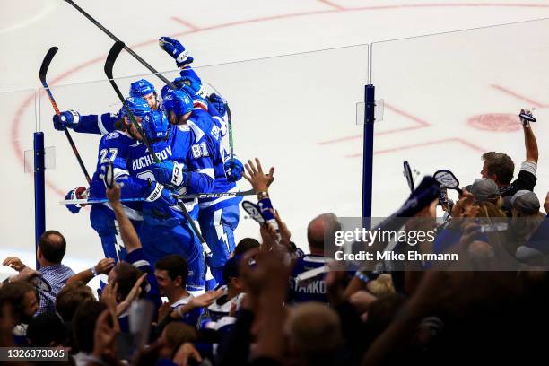 Ondrej Palat of the Tampa Bay Lightning celebrates with teammates Ryan McDonagh, Nikita Kucherov, and Erik Cernak after scoring against Carey Price...