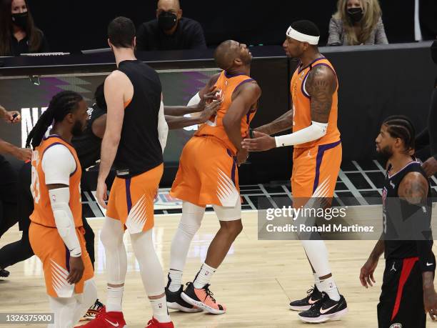 Patrick Beverley of the LA Clippers pushes Chris Paul of the Phoenix Suns during the second half in Game Six of the Western Conference Finals at...