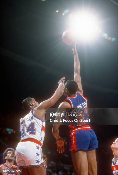 Earl Cureton of the Detroit Pistons shoots over Rick Mahorn of the Washington Bullets during an NBA basketball game circa 1984 at the Capital Centre...