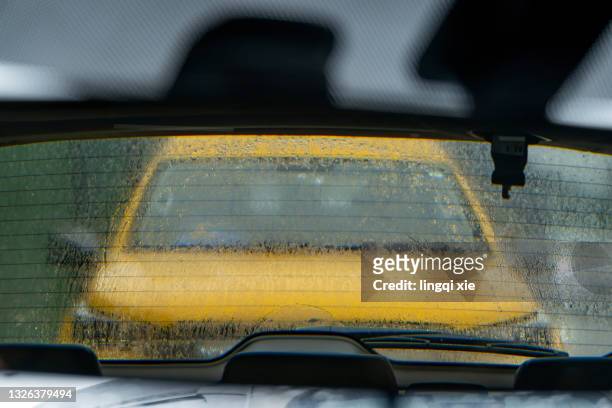 yellow car in the rearview mirror - car rear view mirror stock pictures, royalty-free photos & images