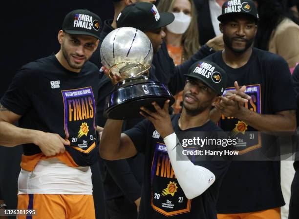 Chris Paul of the Phoenix Suns holds the Western Conference Championship trophy after the Suns defeated the LA Clippers in Game Six of the Western...
