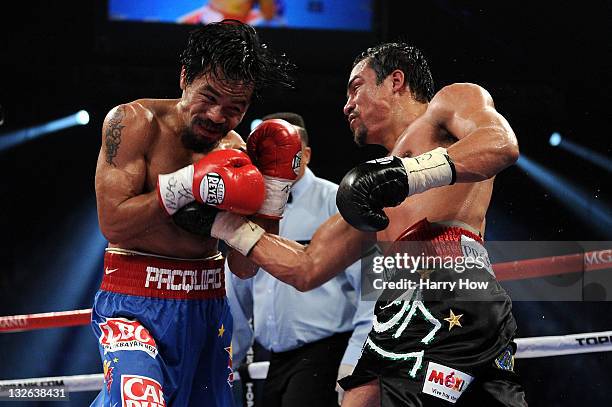 Juan Manuel Marquez throws a right to the body of Manny Pacquiao during the WBO world welterweight title fight at the MGM Grand Garden Arena on...