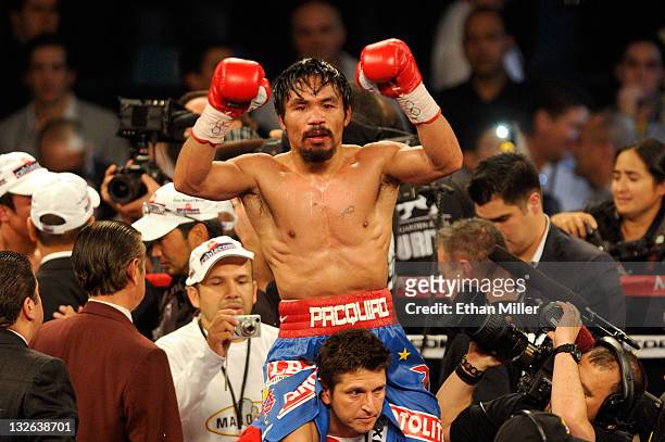 Manny Pacquiao celebrates his majority decision victory against Juan Manuel Marquez in the WBO world welterweight title fight at the MGM Grand Garden...