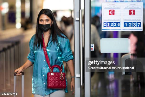 An international passenger from an Etihad Airways flight EY430 from Abu Dhabi, the first flight into Phuket for Phuket Sandbox tourism scheme is seen...