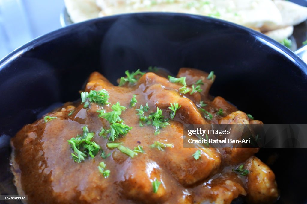 Indian Butter chicken topped with fresh coriander