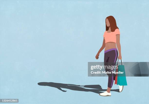 woman carrying shopping bags - sportswear shopping stock-grafiken, -clipart, -cartoons und -symbole
