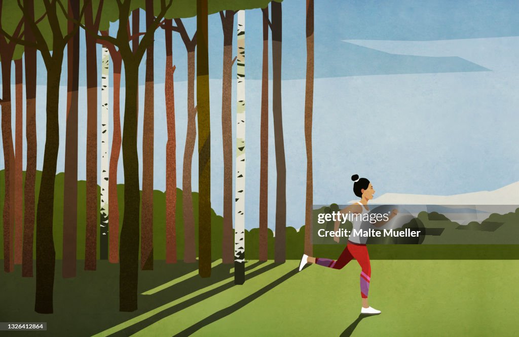 Woman running in sunny rural field with trees