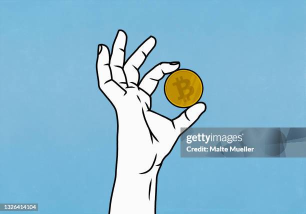 close up hand holding bitcoin on blue background - bitcoin stock-grafiken, -clipart, -cartoons und -symbole