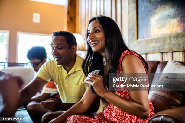 family playing cards at home - asian smiling father son stock pictures, royalty-free photos & images