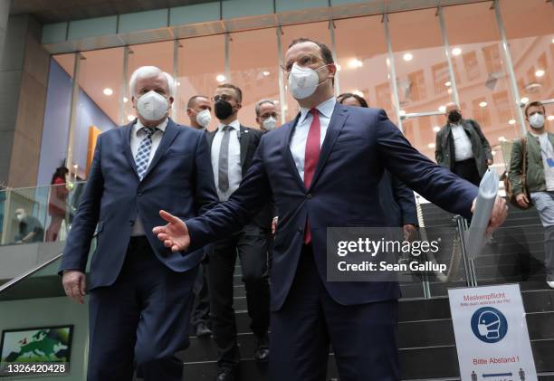 German Interior Minister Horst Seehofer and Health Minister Jens Spahn depart after speaking to the media following the announcement that Germany is...