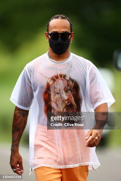 Lewis Hamilton of Great Britain and Mercedes GP walks in the Paddock during previews ahead of the F1 Grand Prix of Austria at Red Bull Ring on July...