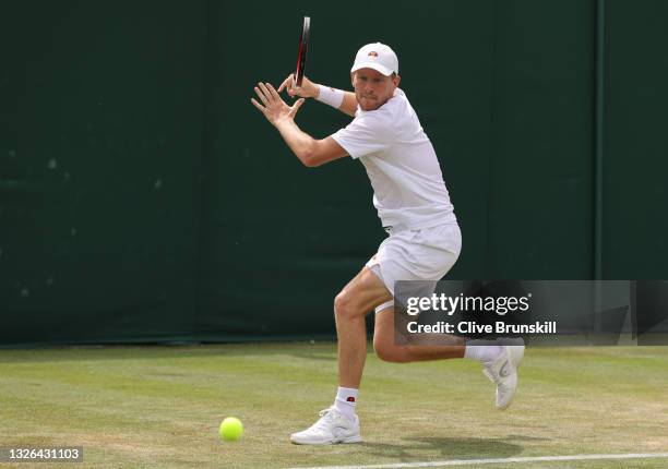 Luke Johnson of Great Britain, playing partner of Anton Matusevich of Great Britain plays a forehand during his men's doubles first round match...