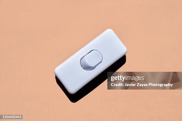 light switch on brown background - toggle switch stock pictures, royalty-free photos & images
