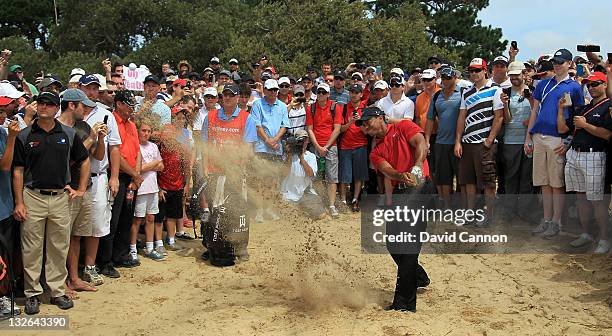 Tiger Woods of the USA plays his second shot from an awful lie in the waste sand left of the fairway for his second shot on the 11th hole during day...