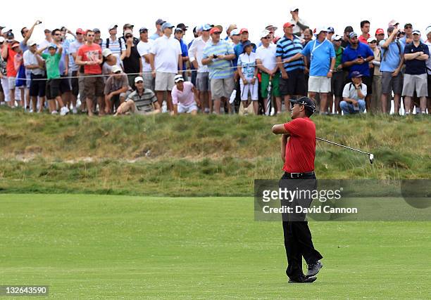 Tiger Woods of the USA reacts to his second shot on the par 5, 8th hole during day four of the 2011 Emirates Australian Open at The Lakes Golf Club...