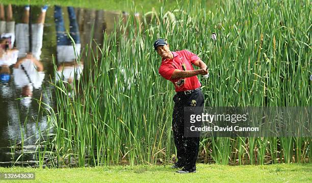Tiger Woods of the USA follows his third shot on the par 4, 13th hole during day four of the 2011 Emirates Australian Open at The Lakes Golf Club on...