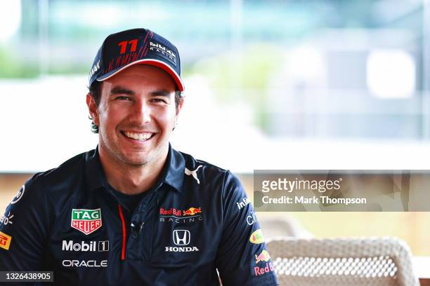 Sergio Perez of Mexico and Red Bull Racing talks in the Paddock during previews ahead of the F1 Grand Prix of Austria at Red Bull Ring on July 01,...